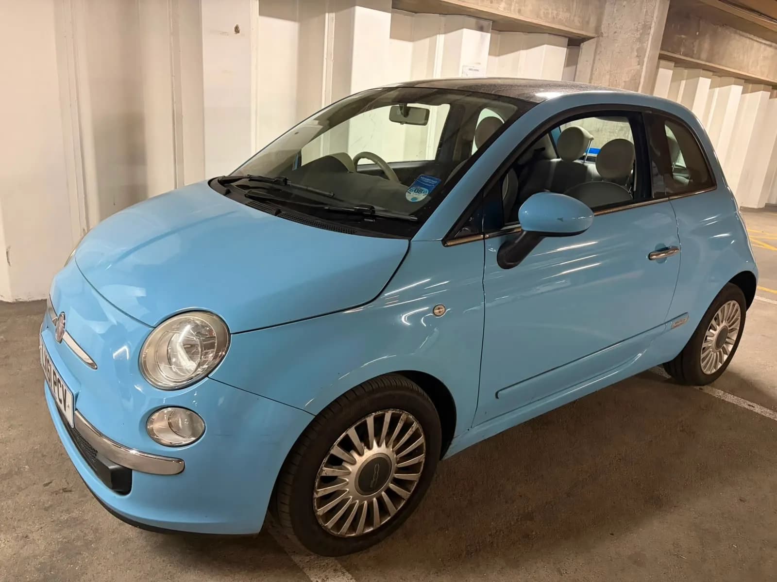 Light blue Fiat 500, front three-quarter view